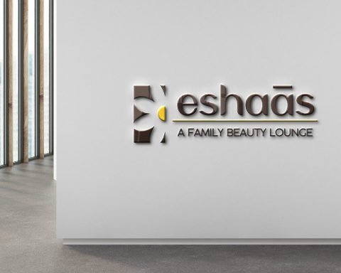 Eshaas 3D logo on a salon reception wall