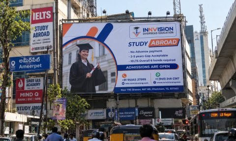 Innvision Overseas Education study abroad hoarding installed at Ameerpet, Hyderabad, above coaching centre signboards