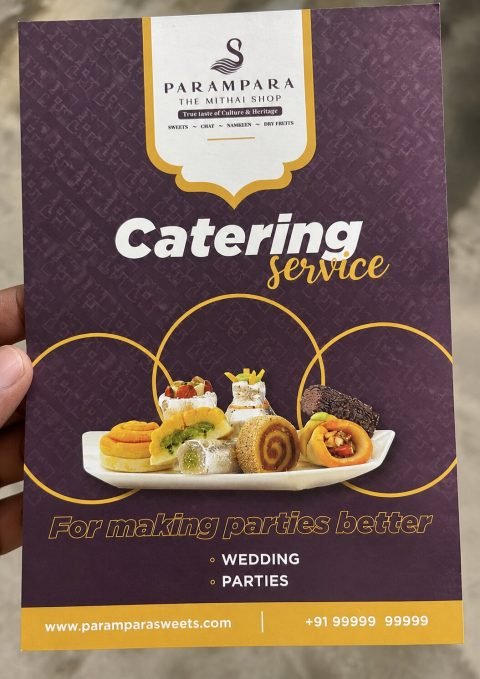 Printed Parampara catering service flyer for weddings and parties held in hand