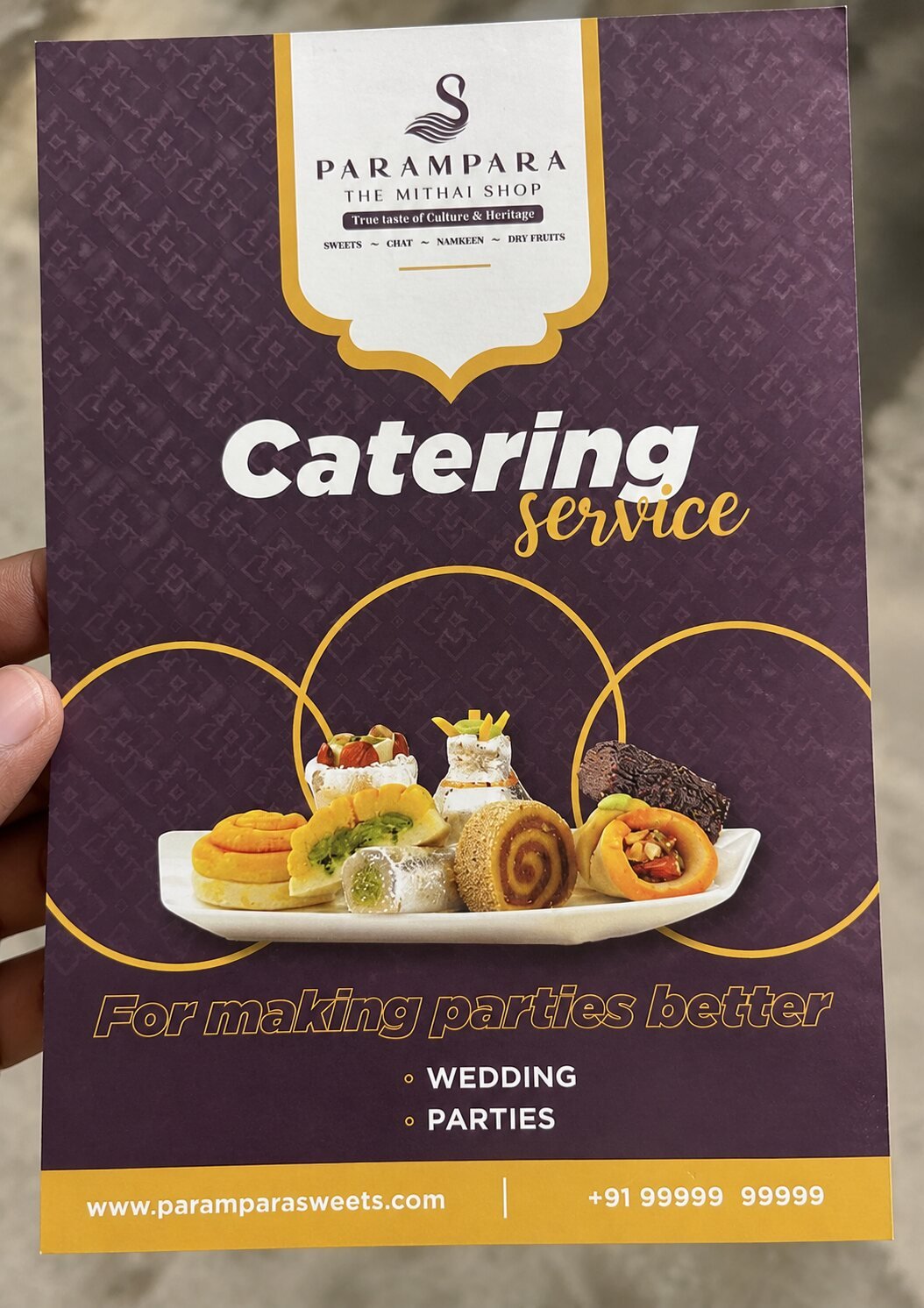 Printed Parampara catering service flyer for weddings and parties held in hand