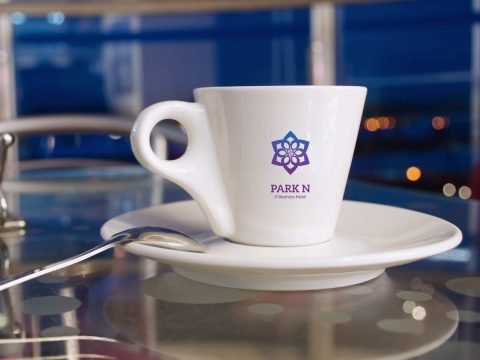 White tea cup with the Park N hotel logo