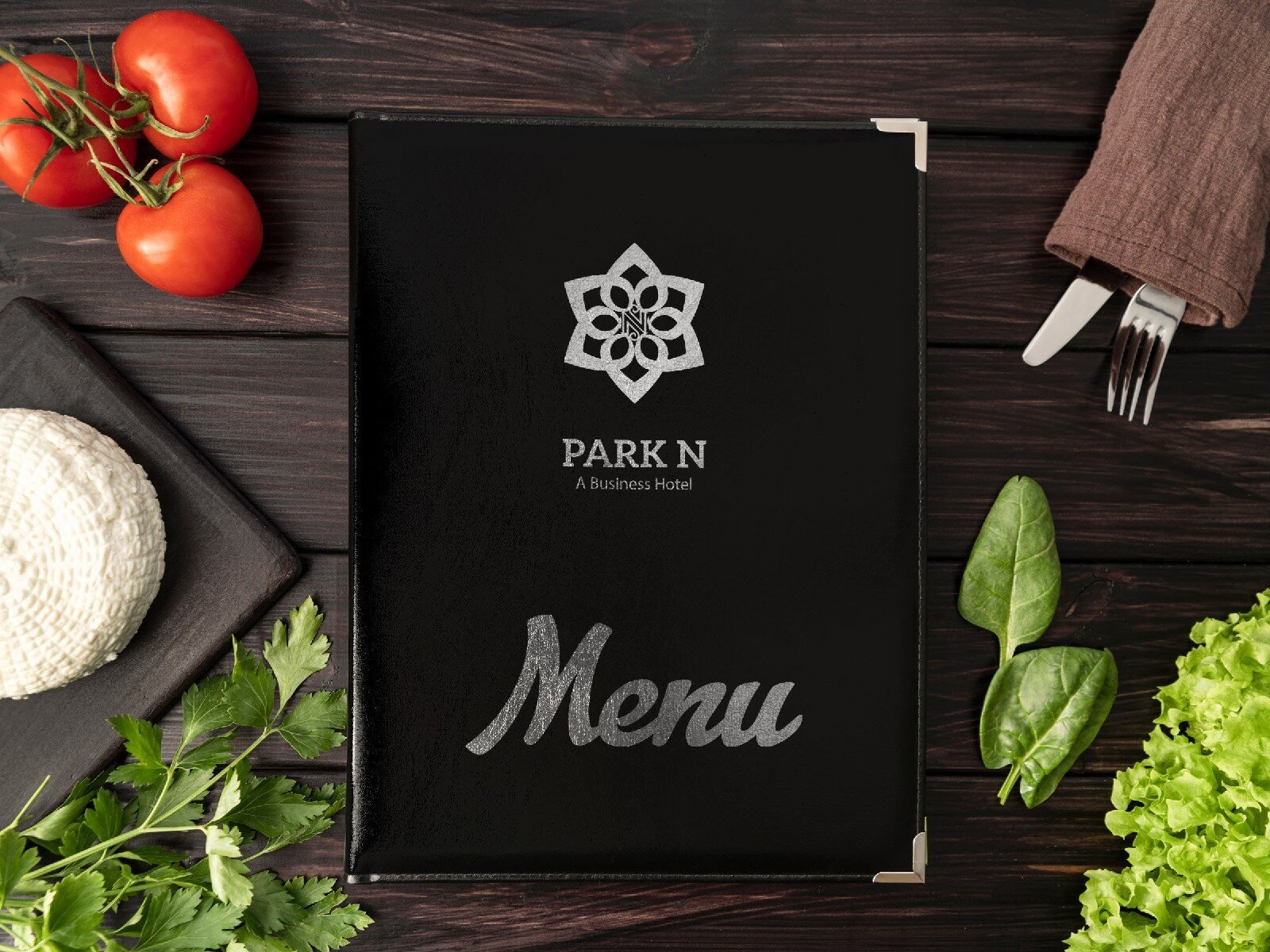 Park N hotel restaurant menu cover on a wooden table with vegetables