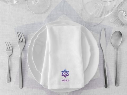 Park N hotel table setting with branded napkin